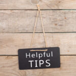 Blackboards with inscription "Helpful TIPS" on wooden background