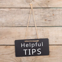 Blackboards with inscription "Helpful TIPS" on wooden background