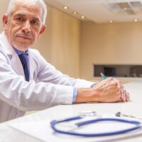 Worried expert male doctor expression with stethoscope in foregr Worried expert male doctor expression with stethoscope in foregr