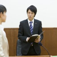 prosecutor talking to person who takes the witness stand prosecutor talking to person who takes the witness stand