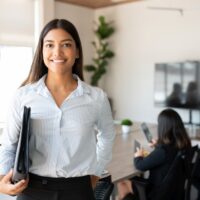 Hispanic female business professional in office boardroom