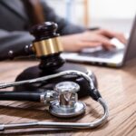 Mallet And Stethoscope On Gavel Over The Office Desk