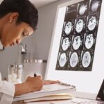 medical woman reading x-ray results of a brain